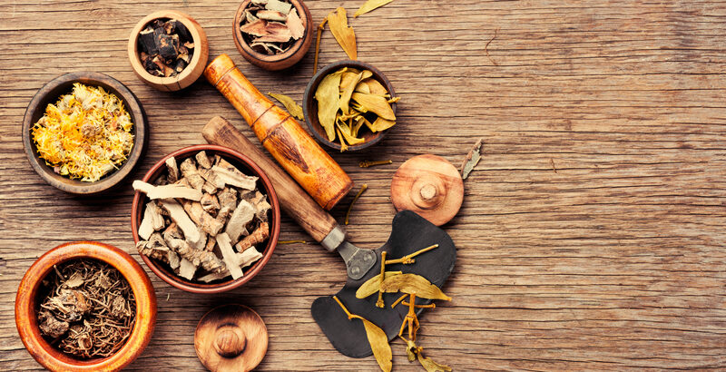 Natural herbal medicine and mortar used in holistic wellness approaches